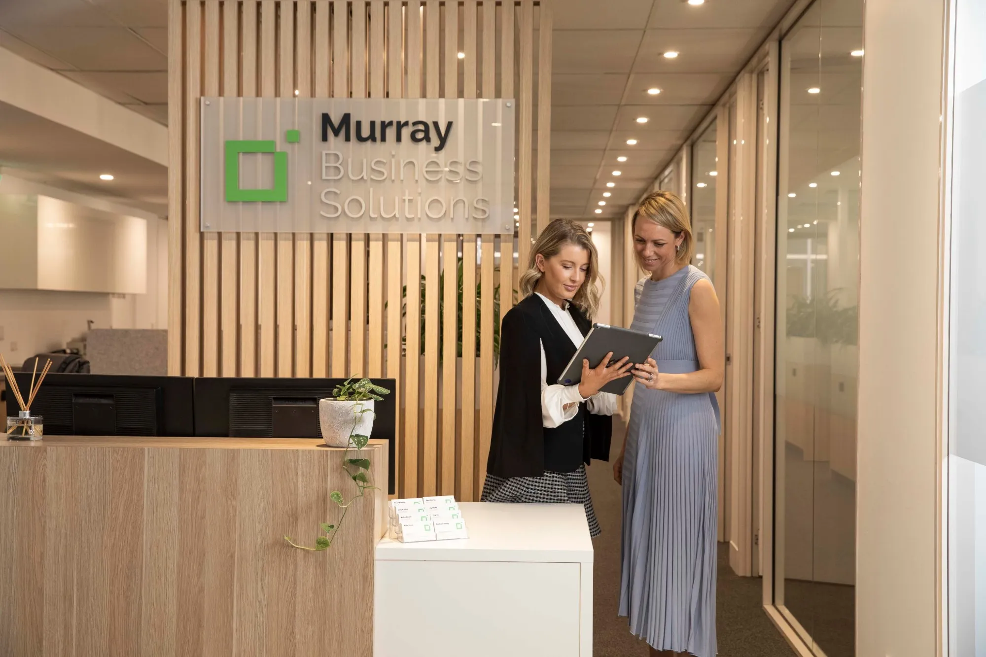 Paula Murray going through a document with a colleague at our reception